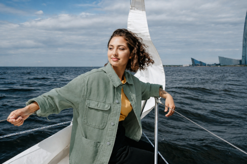 Woman on boat with green coat